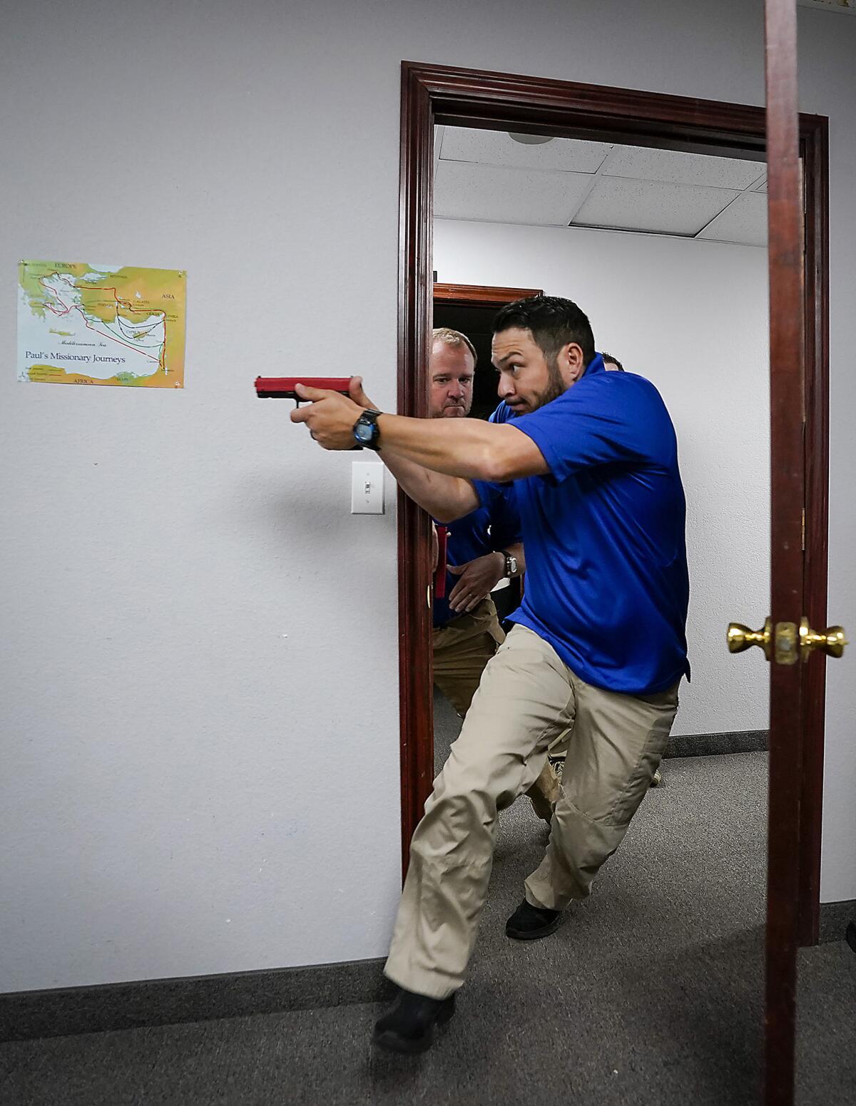 Instructor demonstrates how to enter an active room during security training at Texas church