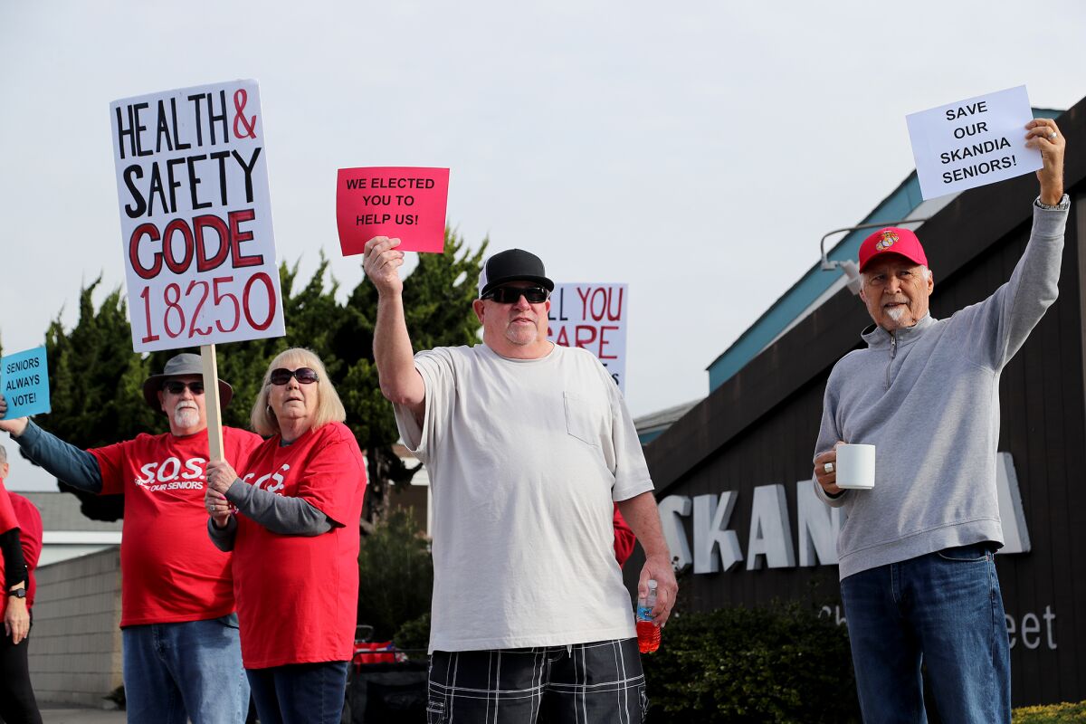 Residents demonstrate against the rent increase at Skandia Mobile Home Park on Tuesday in Huntington Beach.