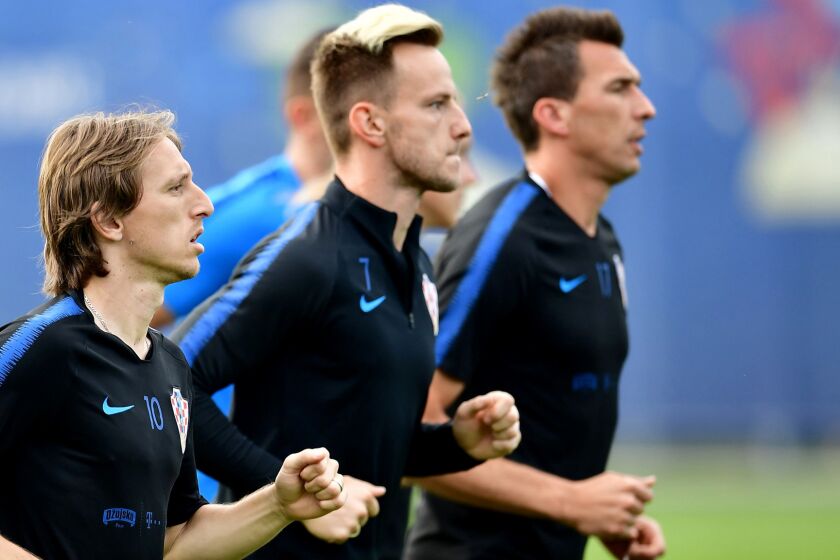 (L to R) Croatia's midfielders Luka Modric, Ivan Rakitic and forward Mario Mandzukic take part in a training session of Croatia national football team at the Roshchino Arena near Saint Petersburg on June 11, 2018, ahead of the Russia 2018 World Cup football tournament. / AFP PHOTO / GIUSEPPE CACACEGIUSEPPE CACACE/AFP/Getty Images ** OUTS - ELSENT, FPG, CM - OUTS * NM, PH, VA if sourced by CT, LA or MoD **