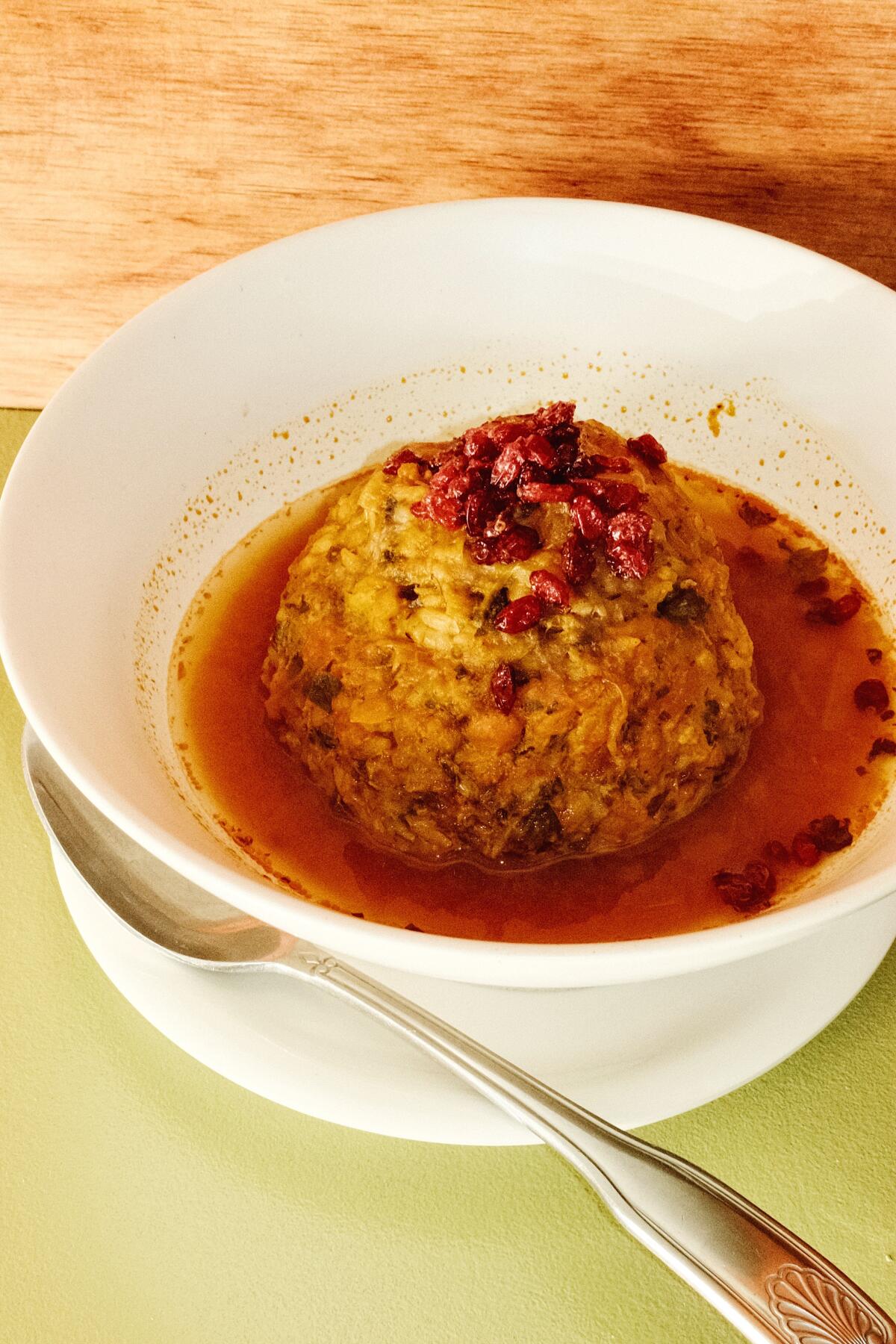 A kofteh tabrizi, or large braised meatball, in a bowl.