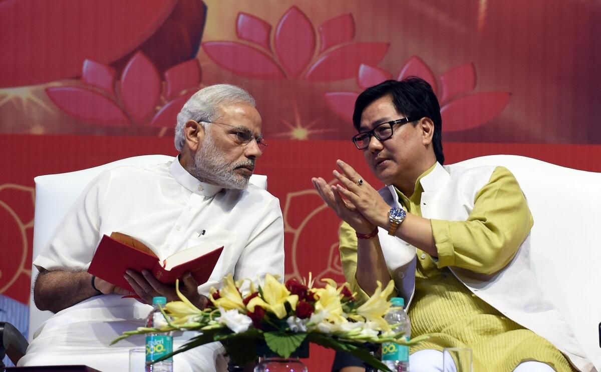 Indian Prime Minister Narendra Modi, left, talks with Junior Home Minister Kiren Rijiju during International Buddha Poornima Diwas celebrations in New Delhi on May 4. A flight was held for Rijiju on June 24, inconveniencing passengers and causing controversy.