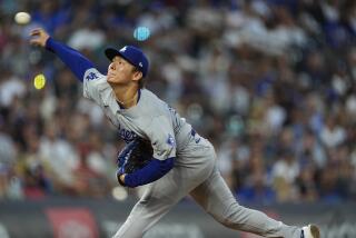 Dodgers starting pitcher Yoshinobu Yamamoto works against the Colorado Rockies in the second inning Saturday in Denver. 