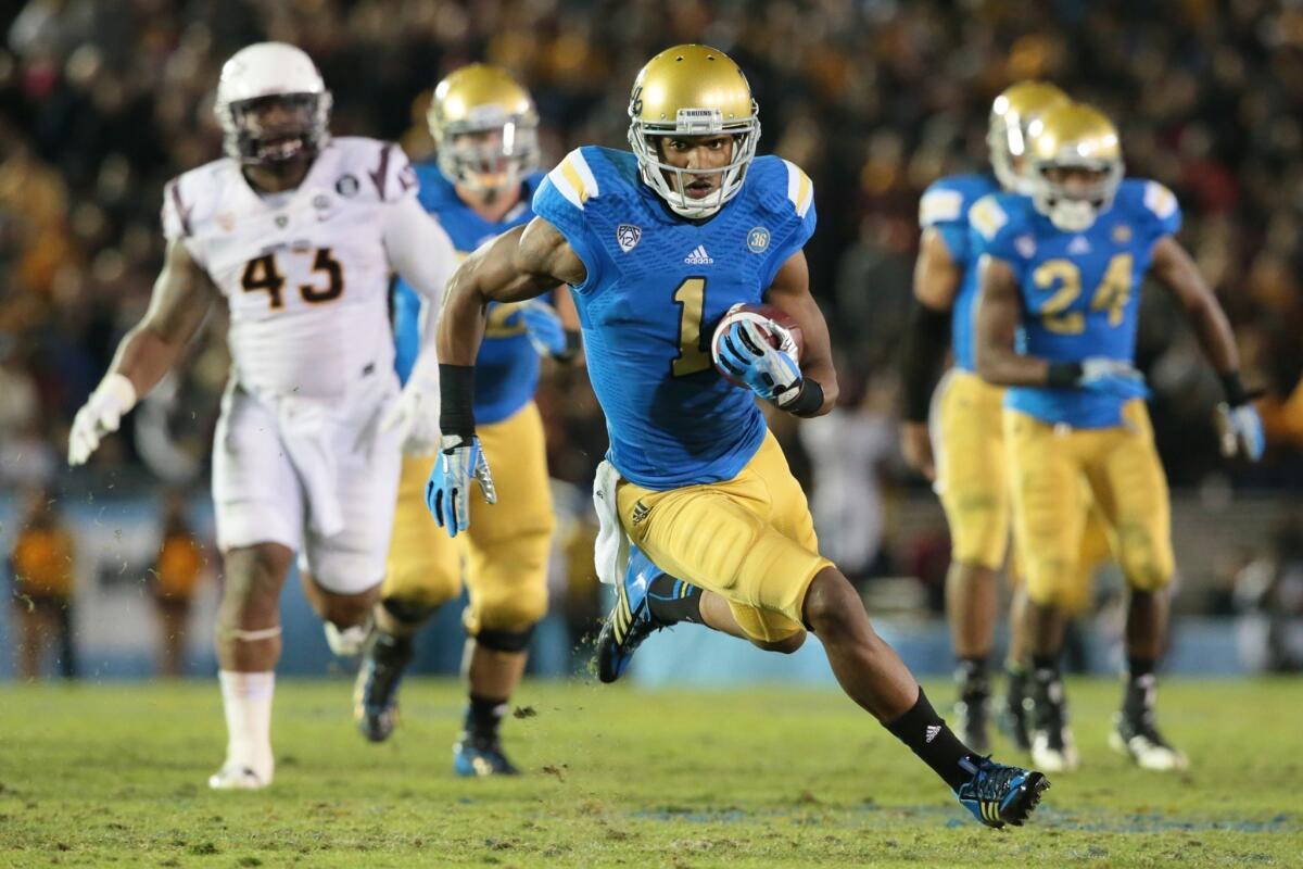 UCLA receiver Shaquelle Evans turns upfield on a 27-yard touchdown pass play to cut the Bruins' deficit against Arizona State to 38-33 in the fourth quarter.