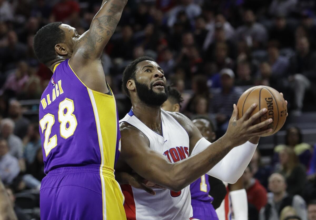 Pistons center Andre Drummond drives down the lane against Lakers center Tarik Black during the first half.