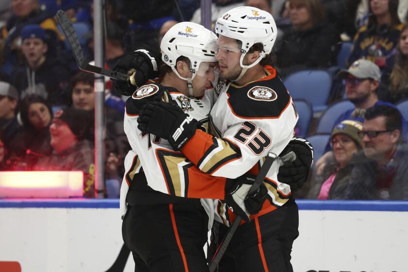 Anaheim Ducks right wing Frank Vatrano (77) celebrates his goal with center Mason McTavish (23) during the second period of an NHL hockey game against the Buffalo Sabres Monday, Feb. 19, 2024, in Buffalo, N.Y. (AP Photo/Jeffrey T. Barnes)