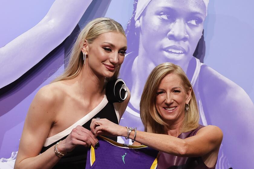 Stanford's Cameron Brink, left, poses for a photo with WNBA commissioner Cathy Engelbert after being selected by the Sparks.