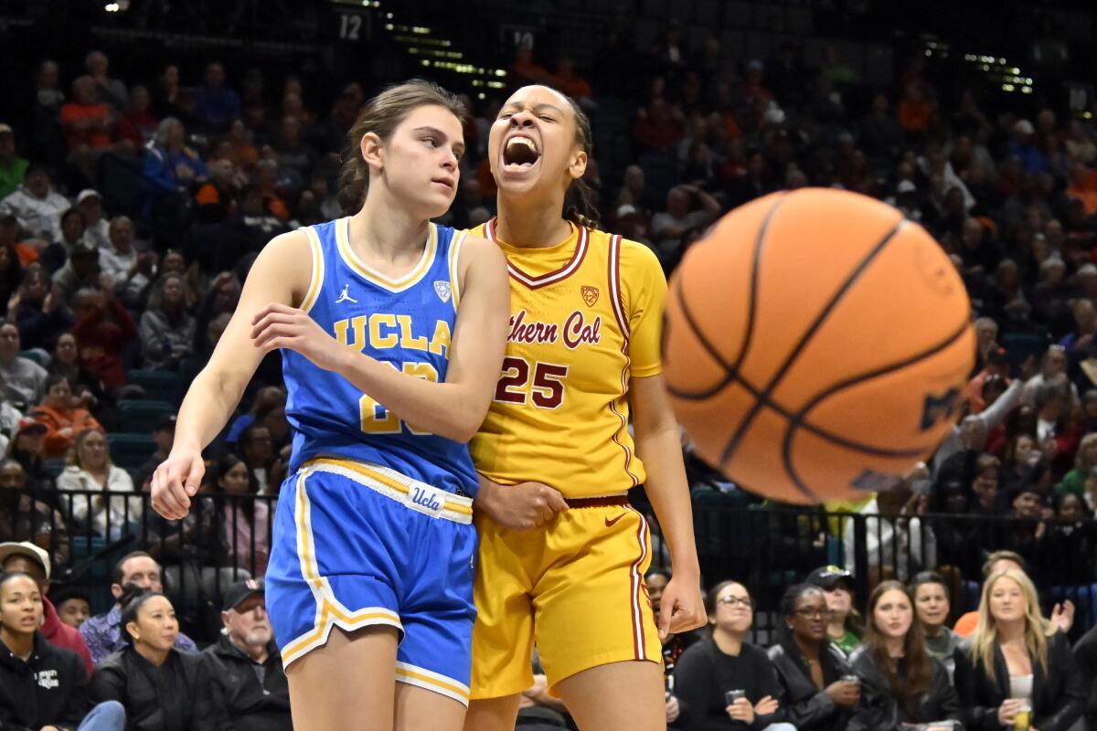 USC guard McKenzie Forbes, right, reacts after a shot-clock violation was called as UCLA forward Gabriela Jaquez.
