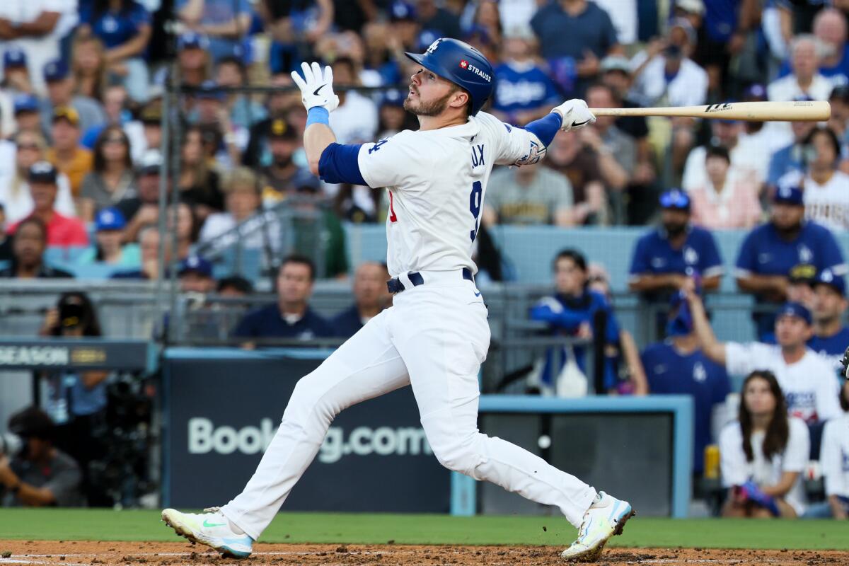 Gavin Lux hits a sacrifice fly to left field in the second inning for the Dodgers on Sunday.