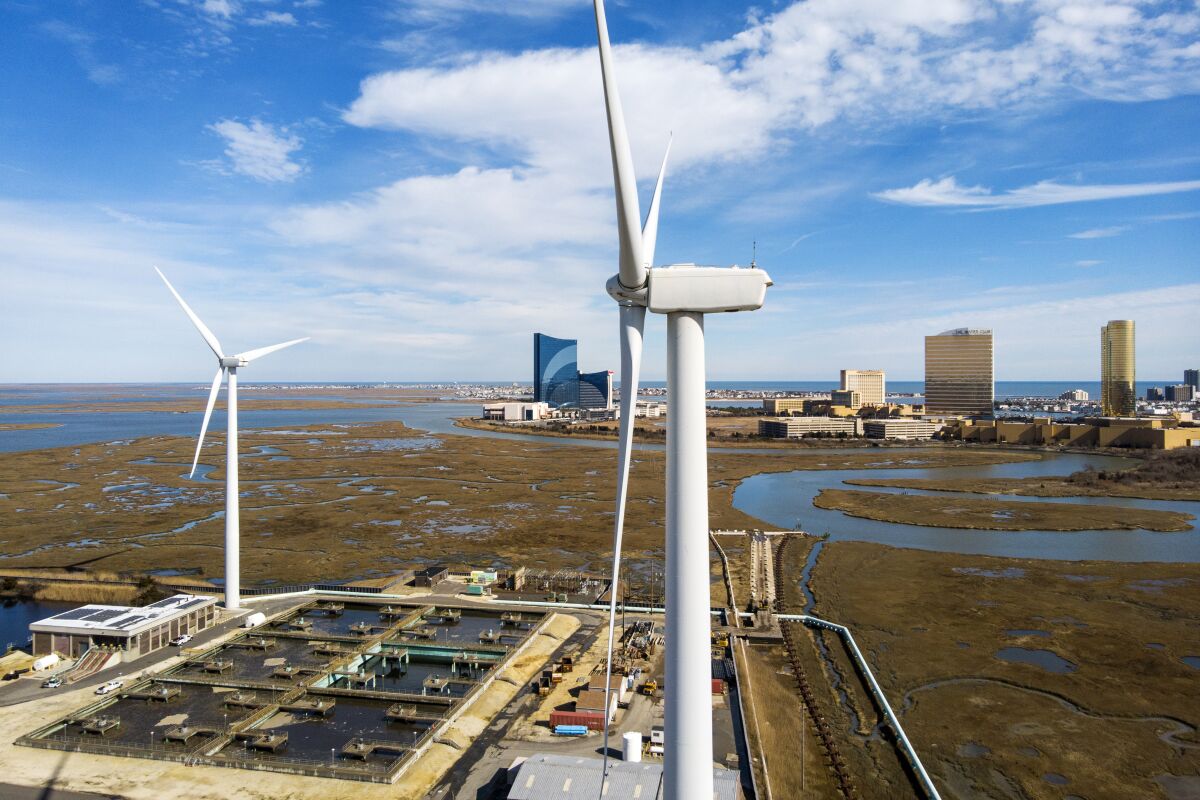 FILE - Wind turbines spin to generate electrical power in Atlantic City, N.J., on Wednesday, Feb. 17, 2021. A report released Tuesday, Oct. 12 by a group studying the economics of the offshore wind industry predicts that the industry’s supply chain will be worth $109 billion over the next decade. (AP Photo/Ted Shaffrey, File)