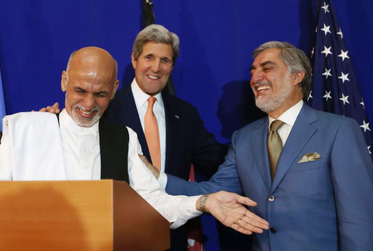 Afghan presidential candidates Abdullah Abdullah, right, and Ashraf Ghani flank U.S. Secretary of State John F. Kerry at a news conference where the rivals announced a deal to end their political standoff.