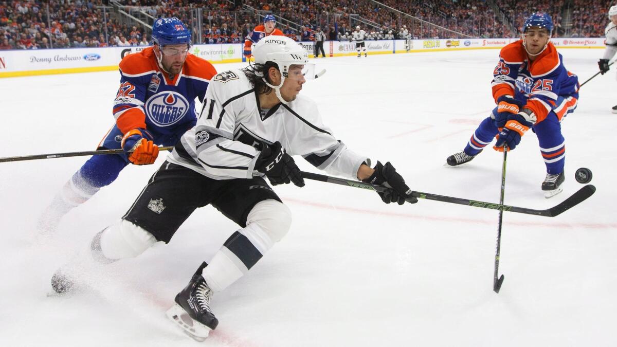 The Kings' Jordan Nolan (71) is chased by Edmonton's Eric Gryba, left, and Darnell Nurse on March 28.
