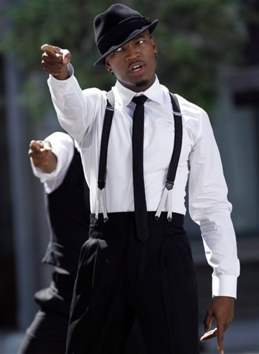 FILE - In this July 21, 2010 file photo, musician Ne-Yo dances while filming a music video for his upcoming single "One in a Million" on the Universal Studios lot in Los Angeles. In an interview with The Associated Press, released on Friday, Sept. 3, 2010, Ne-Yo says T.I. has had many chances, and it's time he gets his act together. (AP Photo/Matt Sayles, File)