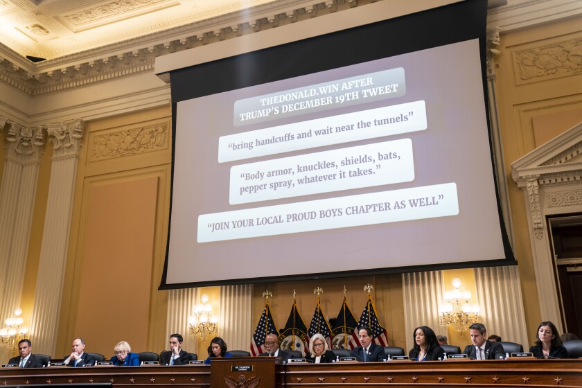 Messages from TheDonald.win website are displayed on the screen during Tuesday's hearing.