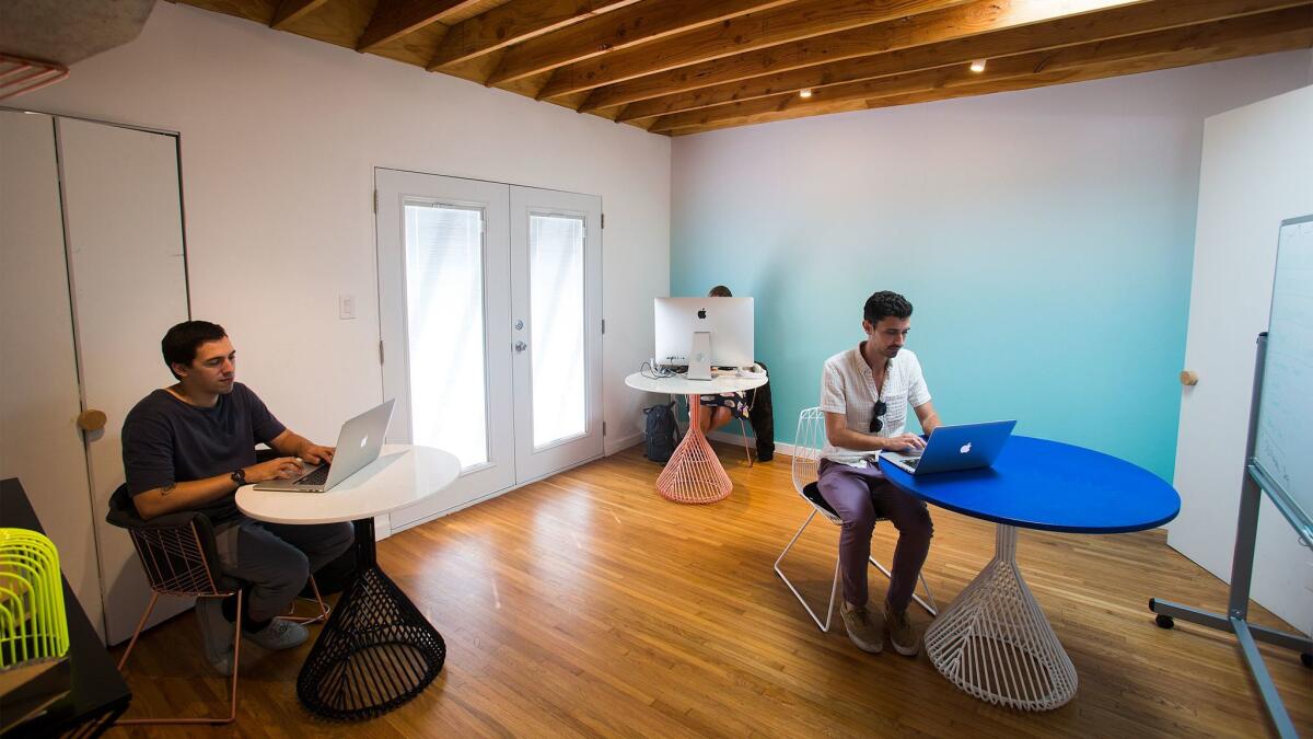 Employees work in an open work space in the home and studio of Bend Goods designer Gaurav Nanda. (Gina Ferazzi / Los Angeles Times)