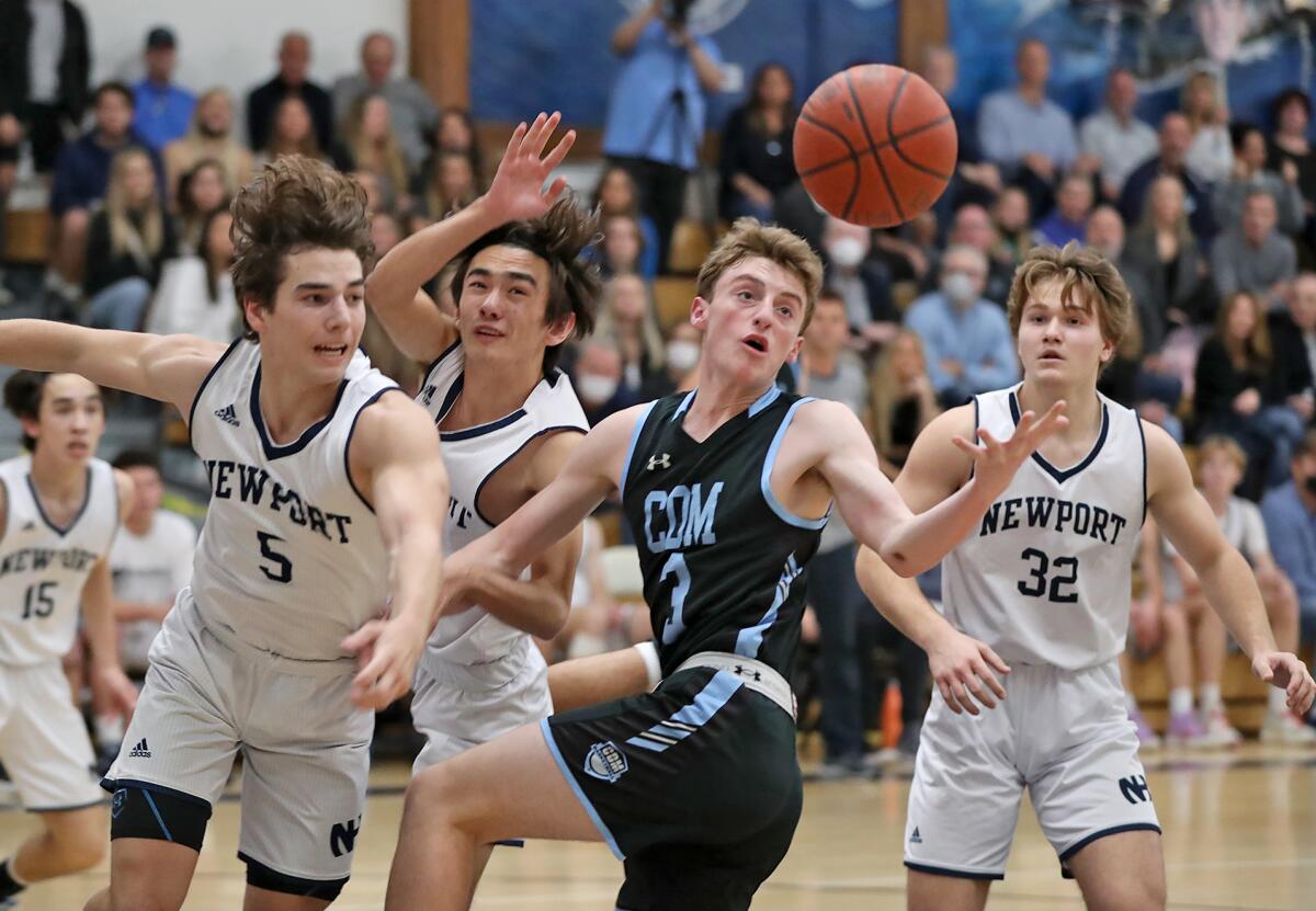 Corona del Mar's Keenan Boyle (3) and Newport Harbor's Brandon Kincaid (5) try to bring in a rebound.