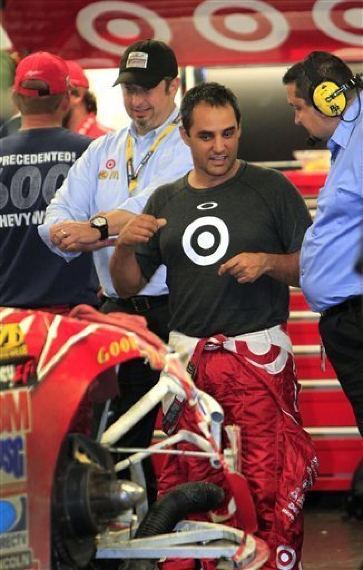 Juan Pablo Montoya, center, of Colombia, talks to team members in his garage after he was involved in a crash in the NASCAR Daytona 500 auto race at Daytona International Speedway in Daytona Beach, Fla., Monday, Feb. 27, 2012. (AP Photo/John Raoux)