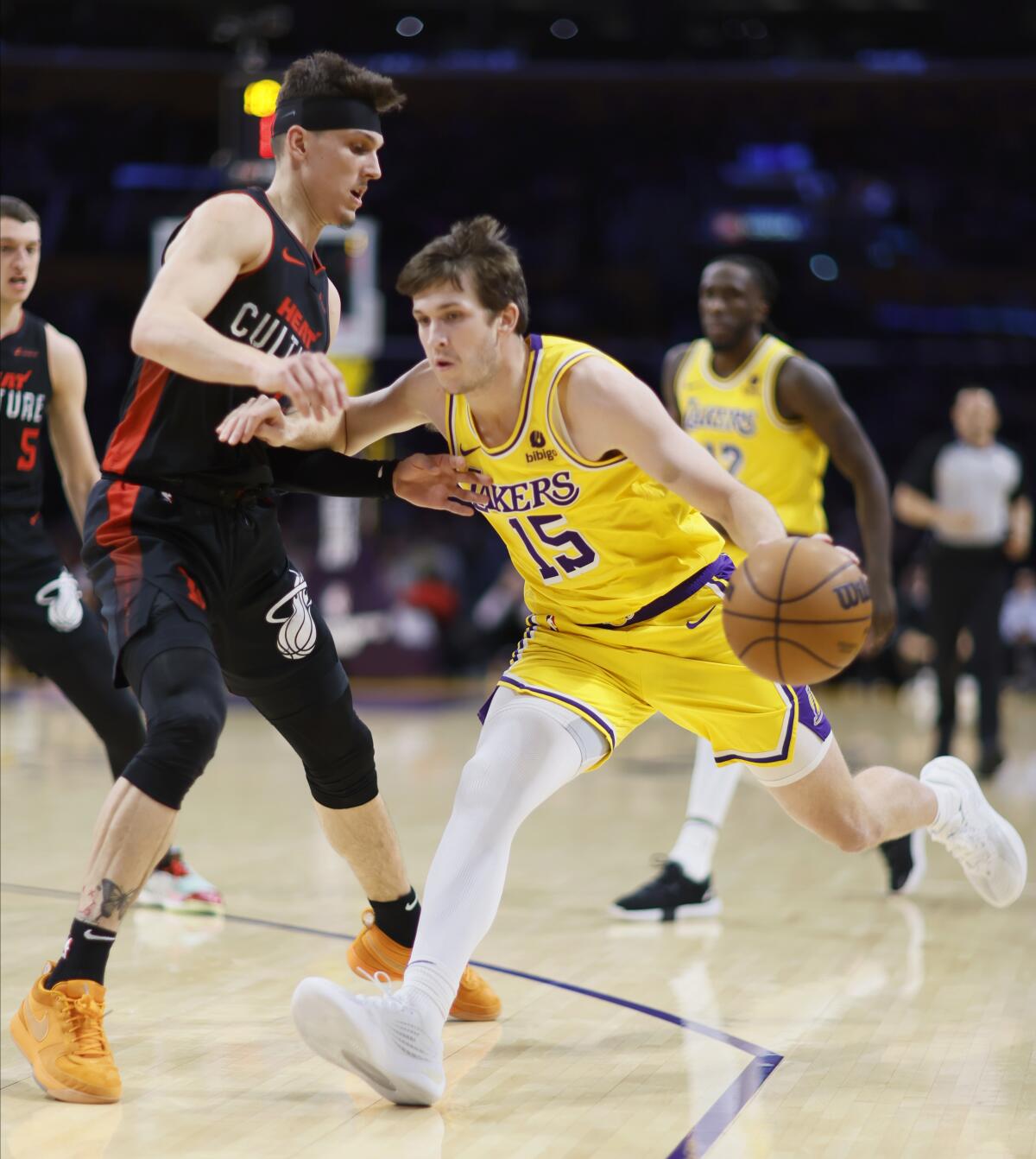 The Lakers' Austin Reaves drives the lane against the Heat's Tyler Herro during Wednesday's game.