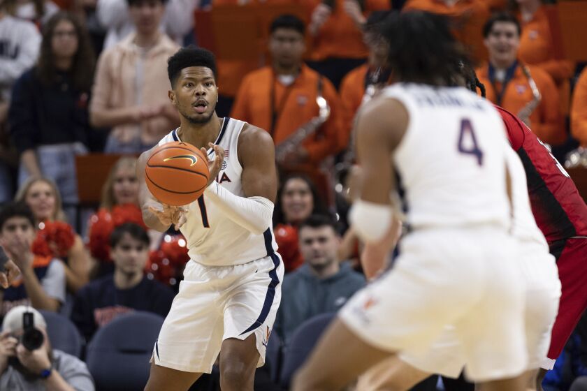 Virginia's Jayden Gardner (1) passes the ball during the first half of the team's NCAA college basketball game against North Carolina State in Charlottesville, Va., Tuesday, Feb. 7, 2023. (AP Photo/Mike Kropf)
