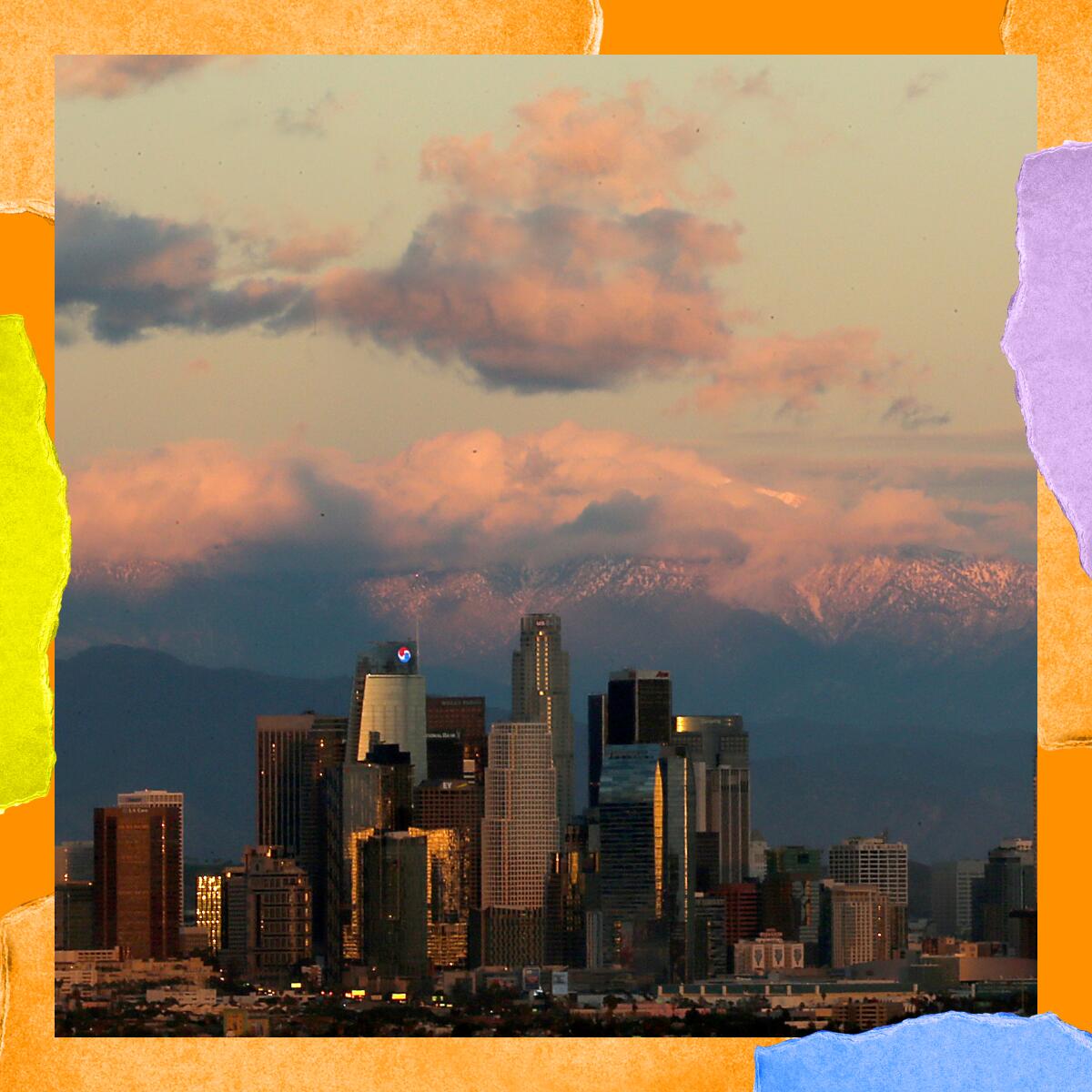 The snow-covered San Gabriel Mountains provide a dramatic backdrop for the downtown Los Angeles skyline.