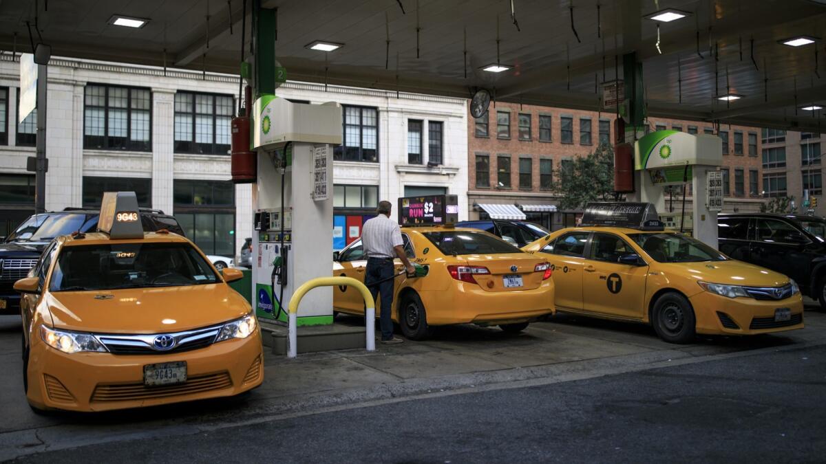 Taxis fuel up at a gas station in Manhattan.