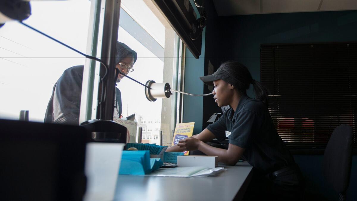 Gabrielle Israel-Smith sells tickets at the 24:1 Cinema on the outskirts of St. Louis, Missouri.