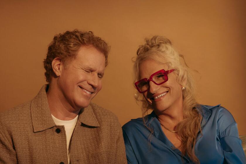 Will Ferrell and Harper Steele sit next to each other and smile for a portrait