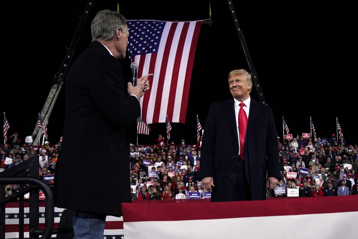 Sen. David Perdue and President Trump onstage at a campaign rally in Valdosta, Ga.