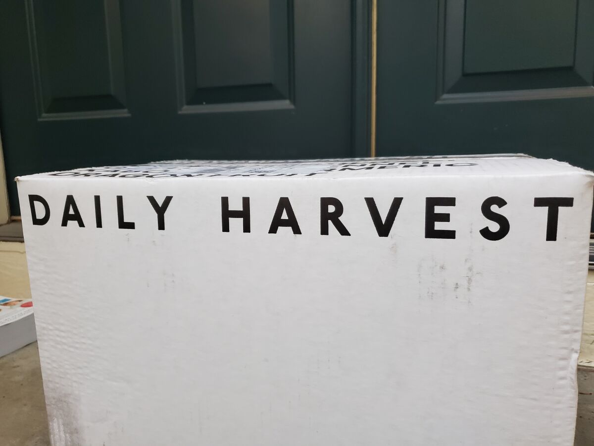 A white cardboard box labeled Daily Harvest