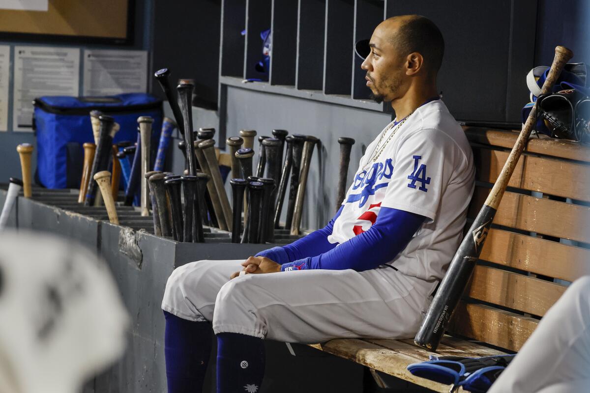 Mookie Betts sits in the dugout during Game 2 of the NLDS against the Arizona Diamondbacks on Oct. 9.