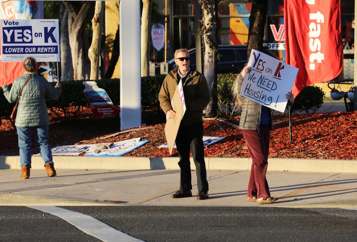 Costa Mesa residents on Nov. 3  rally in support of Measure K at the intersection of Harbor Boulevard and Baker Street.