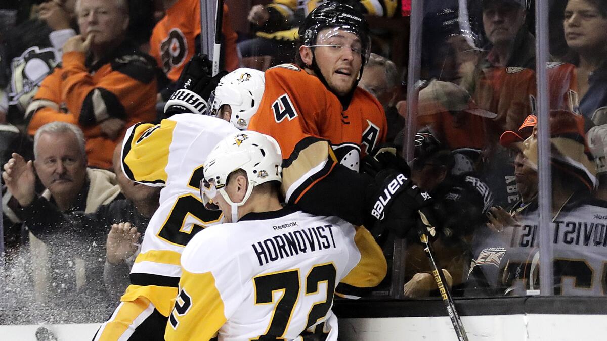 Ducks defenseman Cam Fowler is checked by Pittsburgh's Patric Hornqvist and Scott Wilson during a Nov. 2 game at Honda Center.