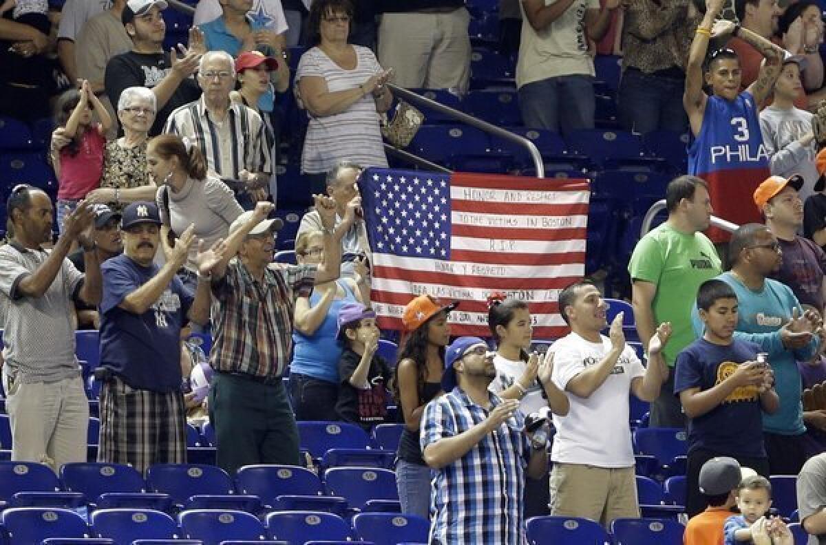 New York fans honor Boston bombing victims by singing the Red Sox theme song "Sweet Caroline" at Yankee Stadium.