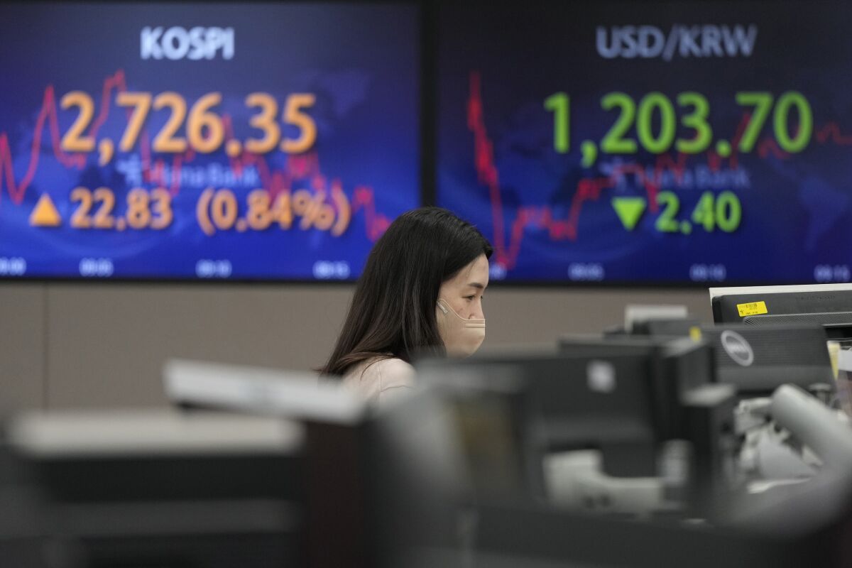A currency trader watches monitors at the foreign exchange dealing room of the KEB Hana Bank headquarters in Seoul, South Korea, Thursday, March 3, 2022. Asian stock markets rebounded Thursday and oil prices climbed higher after the head of the Federal Reserve said he supports a smaller rise in interest rates than some expected. (AP Photo/Ahn Young-joon)