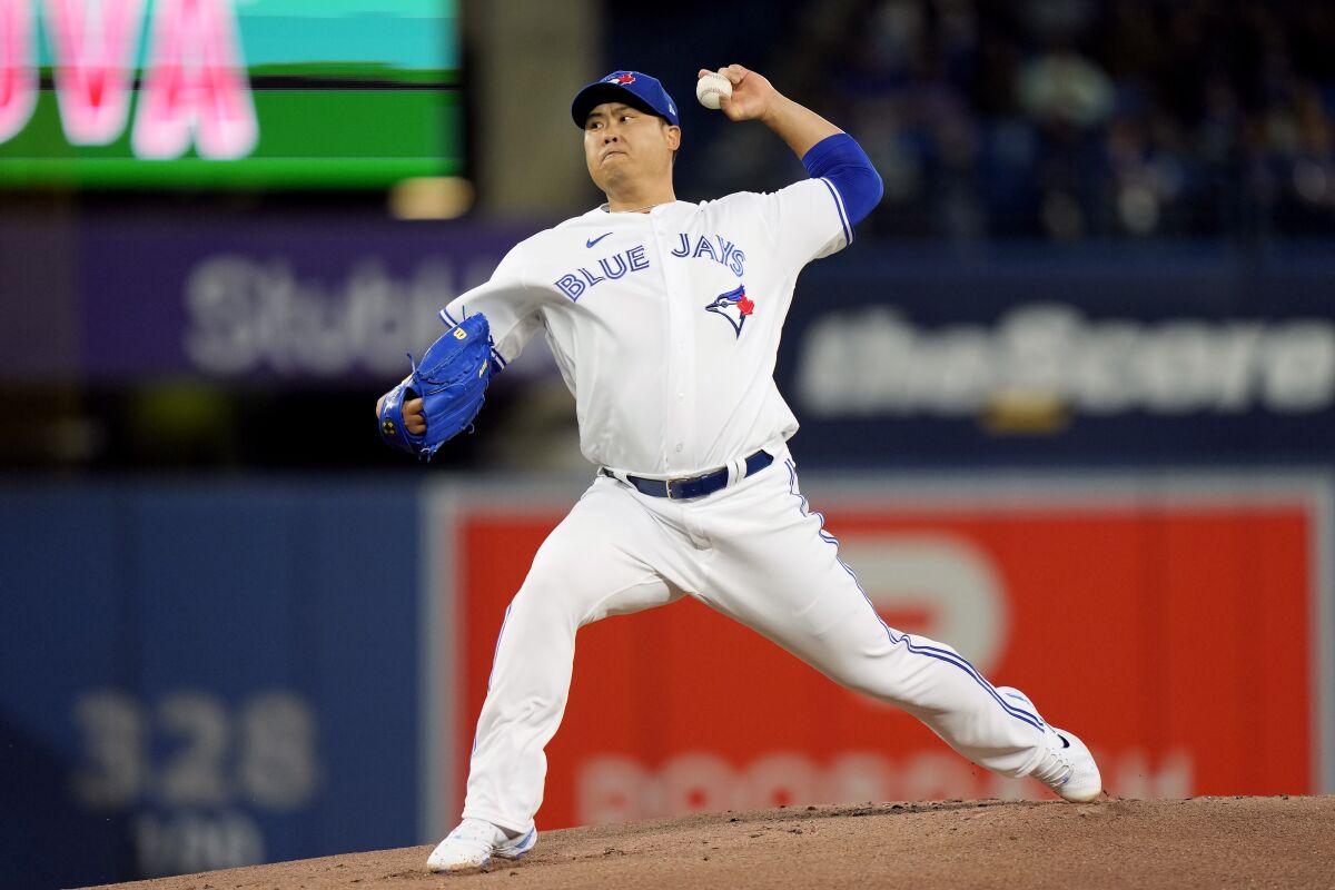 Toronto Blue Jays starting pitcher Hyun Jin Ryu (99) works against the Oakland Athletics during the first inning of an MLB baseball game in Toronto, Saturday, April 16, 2022. (Frank Gunn /The Canadian Press via AP)