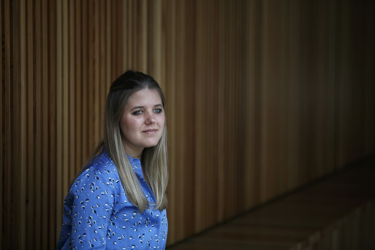 Tabitha Bell, 20, pauses for photos in Irvine, Calif., Tuesday, Aug. 4, 2020. Bell, a former student with disabilities at an elite private school in Utah, says in a lawsuit that administrators mishandled her 2017 sexual assault allegation as she endured bullying from classmates. She's seeking $10 million in damages. (AP Photo/Jae C. Hong)