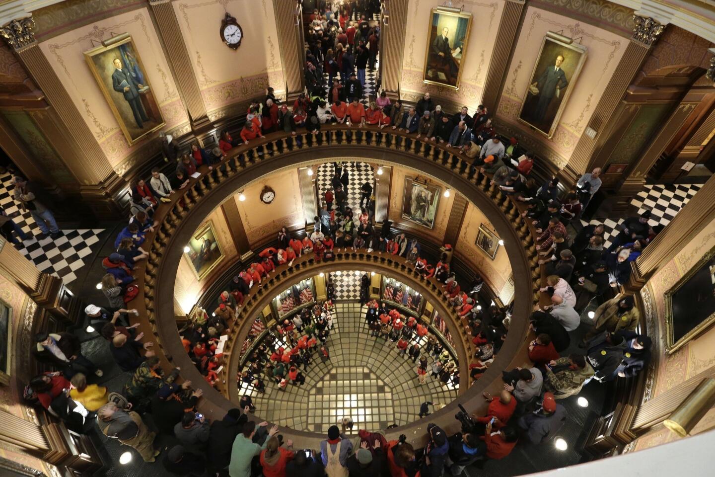Protesters gather for a rally in the Michigan Capitol rotunda in Lansing.