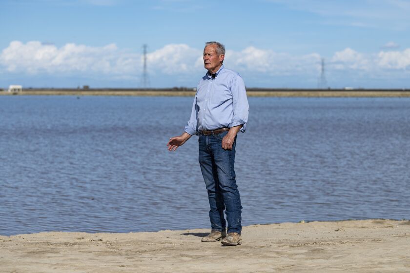 In this photo provided by the California Department of Water Resources, Don Cameron, general manager of Terranova Ranch, poses as recharge water stands in this fallow field at Terranova as part of a groundwater recharge system designed to divert floodwater from the Kings River in Fresno County, on March 13, 2023. (Andrew Innerarity/California Department of Water Resources via AP)