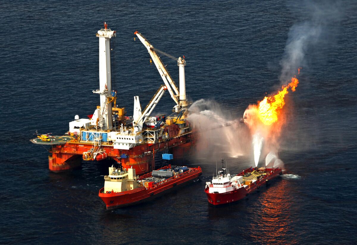 Fires burn excess gas released from an oil rig.