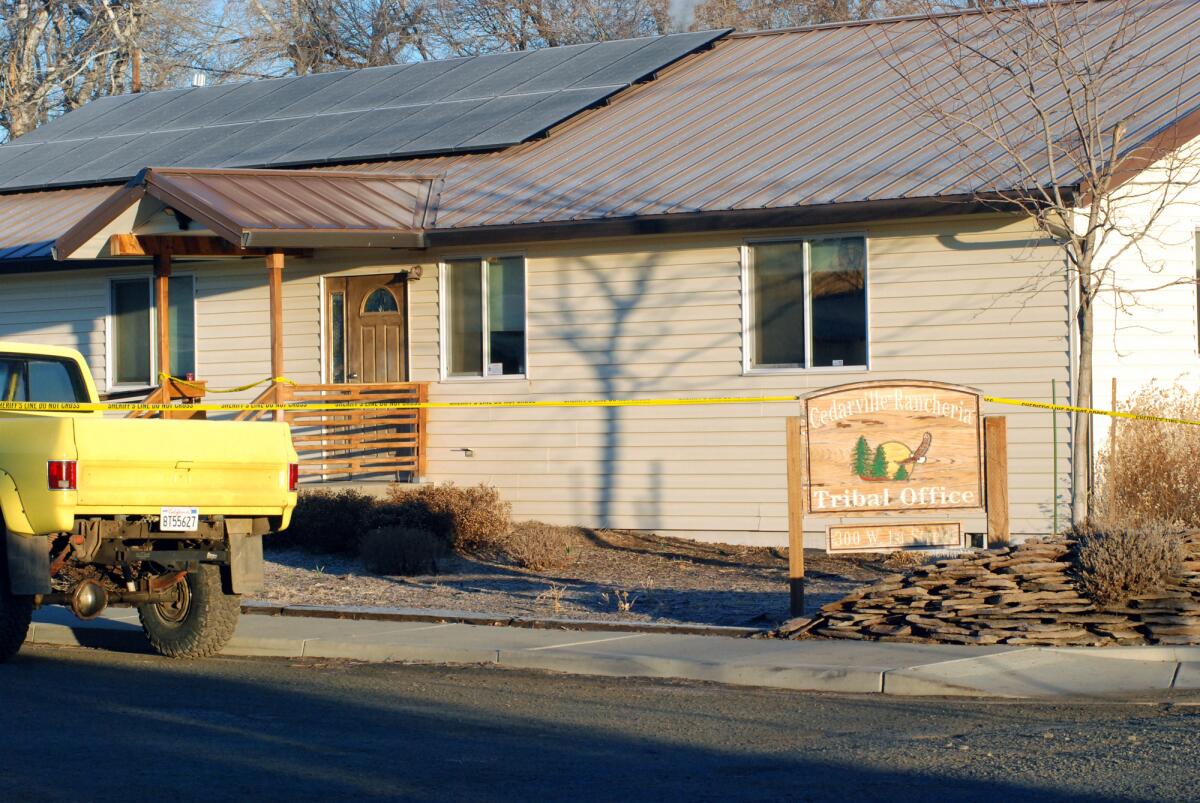 Crime scene tape surrounds the tribal headquarters of the Cedarville Rancheria on Friday in Alturas, Calif., where police say an eviction hearing turned deadly as a woman who once served as a tribal leader allegedly opened fire, killing four people and critically wounding two others in a gun and knife attack.