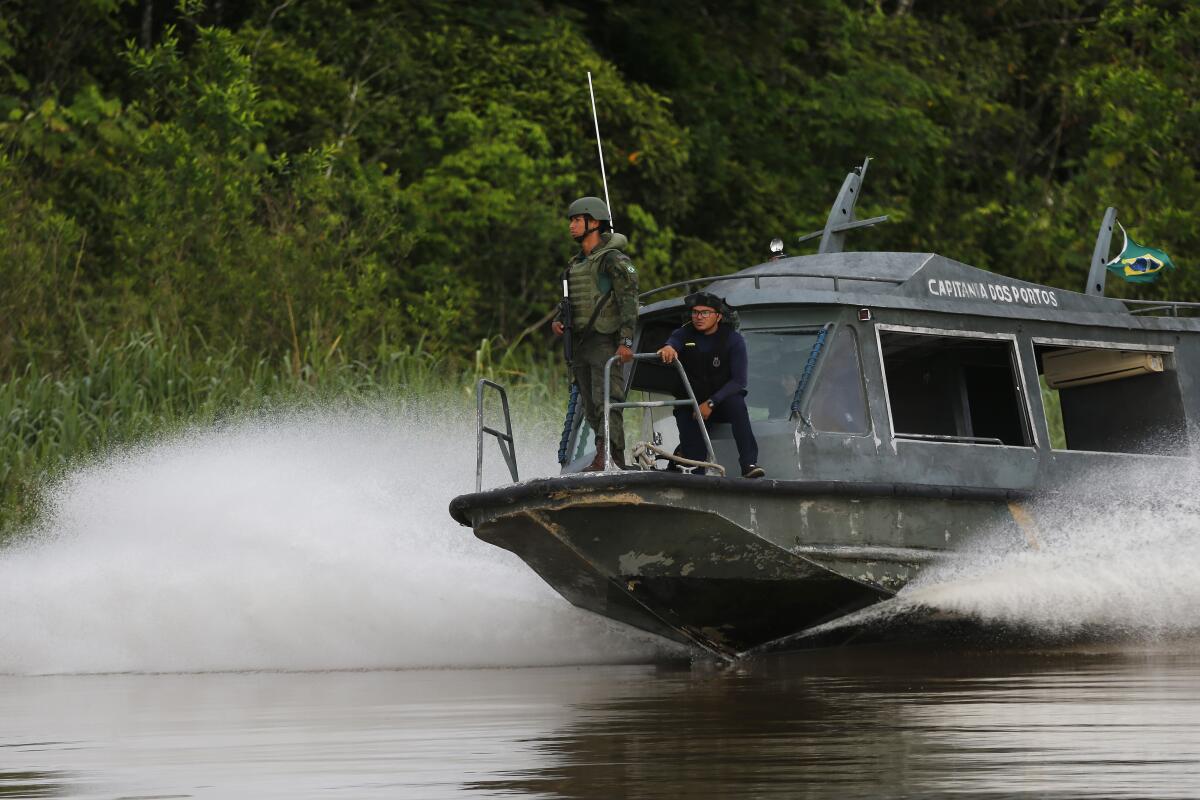 Navy sailors search for British journalist Dom Phillips and Indigenous affairs expert Bruno Araujo Pereira aboard a speedboat on the Itaquai river, in the Javari Valley Indigenous territory, Atalaia do Norte, Amazonas state, Brazil, Thursday, June 9, 2022. Phillips and Araujo Pereira are missing in a remote part of Brazil's Amazon region marked by violent conflicts between fishermen, poachers and government agents. (AP Photo/Edmar Barros)