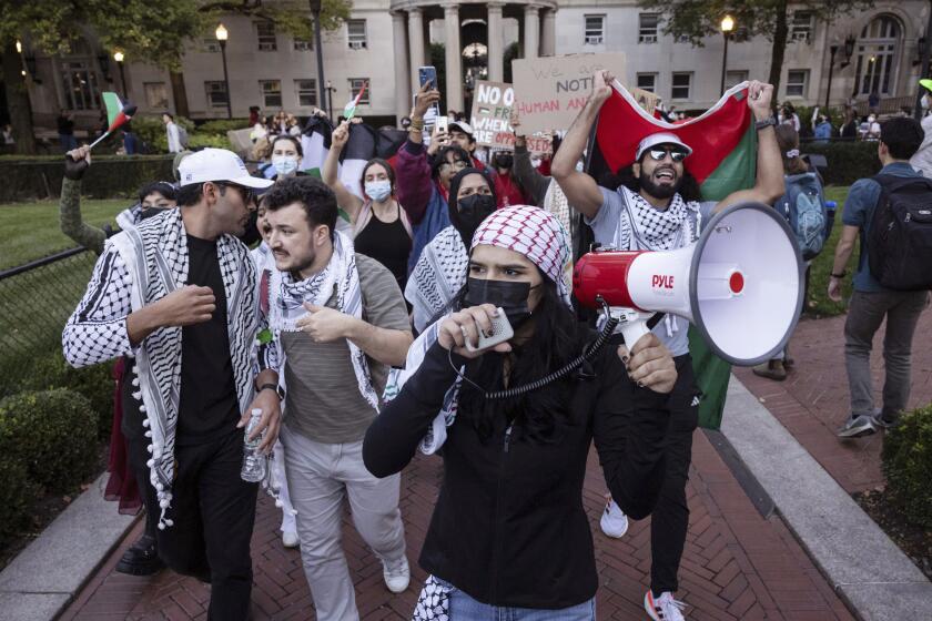 Palestinian supporters demonstrate during a protest at Columbia University, Thursday, Oct. 12, 2023, in New York. Hamas militants launched an unprecedented surprise attack Saturday killing hundreds of Israeli civilians, and kidnapping others. The Israeli military is pulverizing the Hamas-ruled Gaza Strip with airstrikes. (AP Photo/Yuki Iwamura)