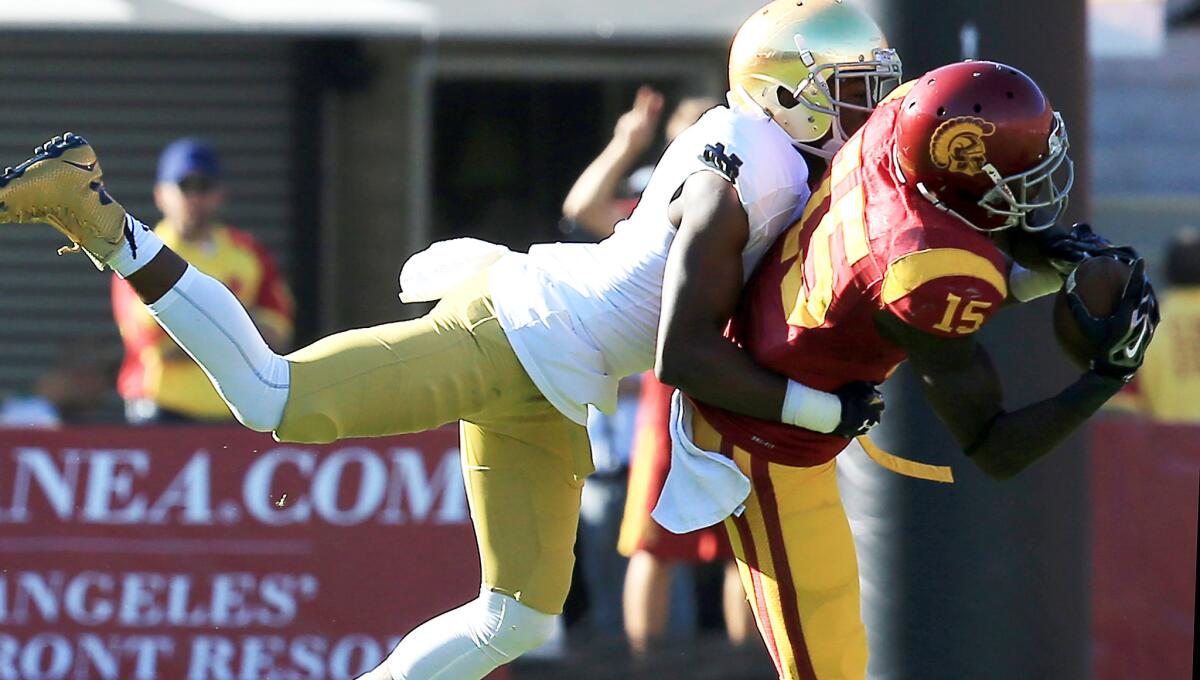 Notre Dame cornerback Devin Butler tries to break up a pass to USC receiver Nelson Agholor during a game in 2014.