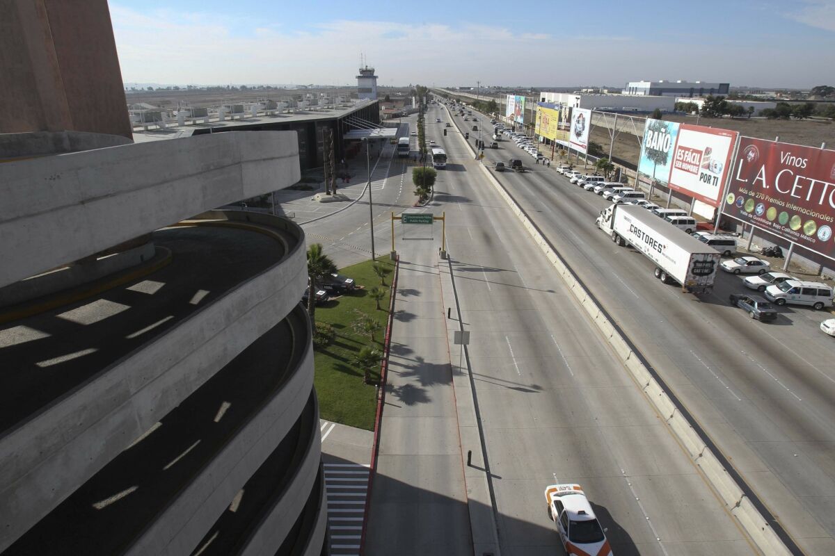 Tijuana airport has recently undergone extensive remodeling in an effort for a more enjoyable travel experience. There are also plans to connect the airport with a terminal on the US side. This is the view looking west from the top of the airport parking structure with the Tijuana International airport at left and the US border to the right.
