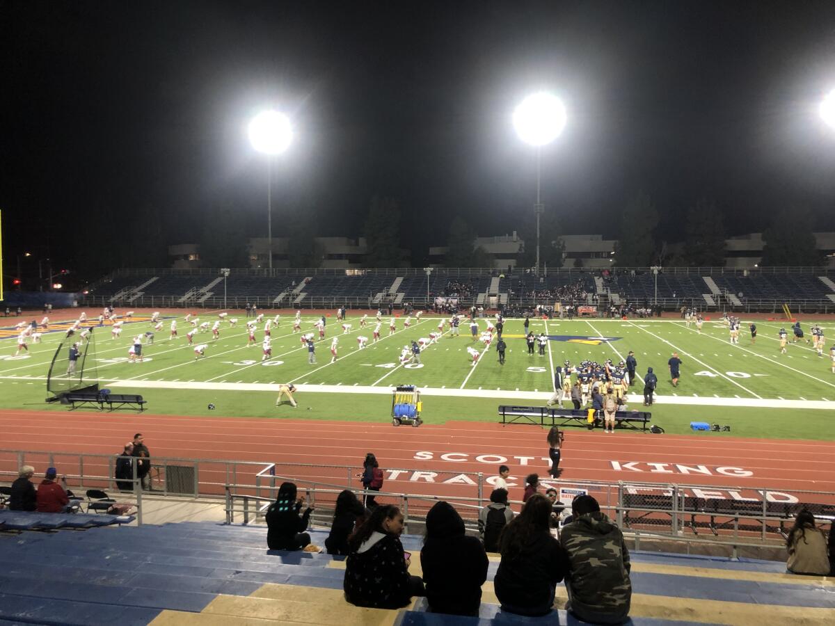 Teams warm up before a football game at Birmingham High.