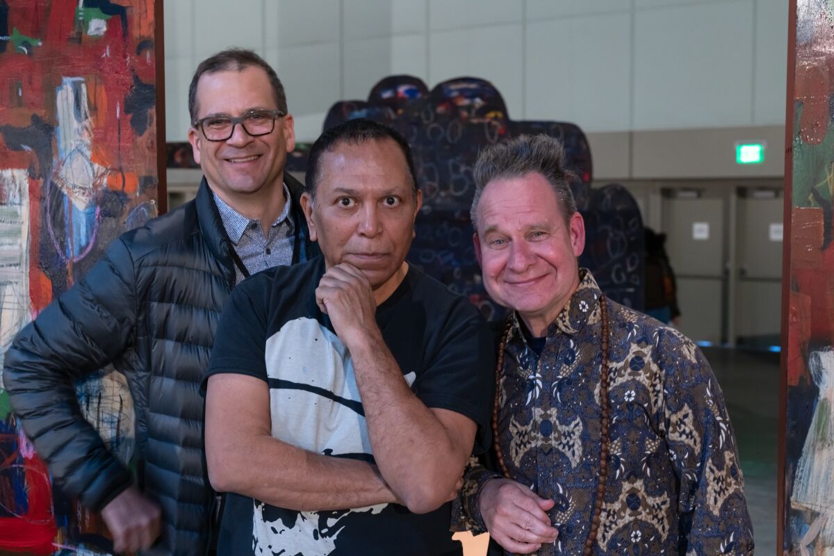 Chon Noriega, Gronk and set designer Gronk and director Peter Sellars at the L.A. Art Show in 2020.