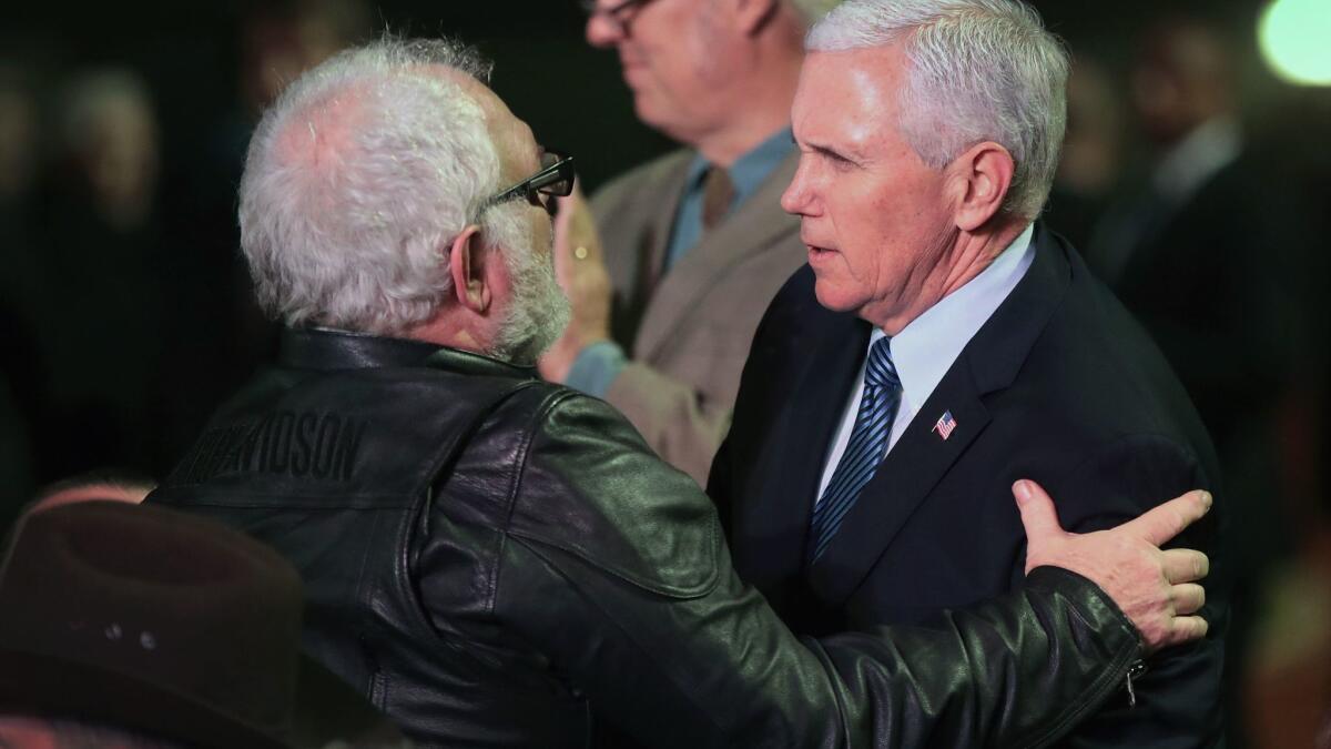 Vice President Mike Pence greets Stephen Willeford at a memorial service in Floresville, Texas, on Nov. 8. Willeford confronted the gunman during the church shooting in nearby Sutherland Springs on Nov. 5.