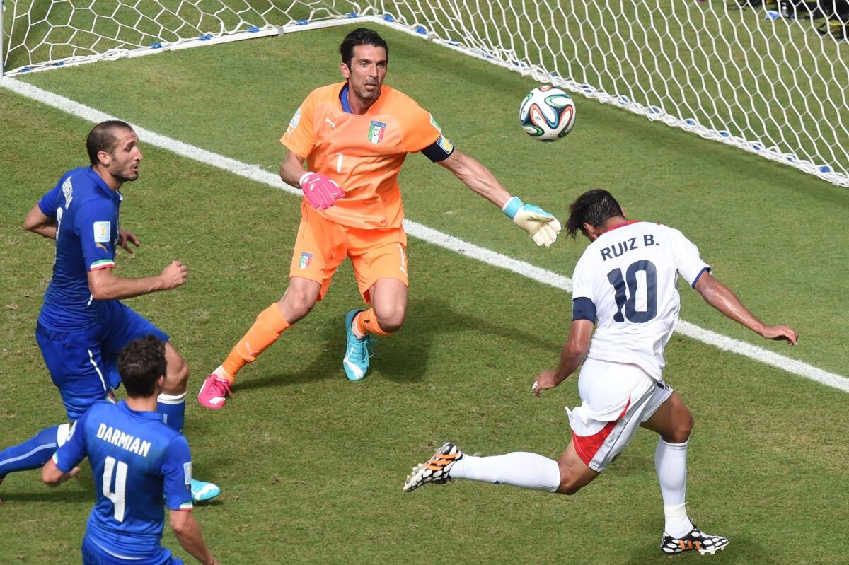 Costa Rica forward Bryan Ruiz heads the ball to score past Italy goalkeeper Gianluigi Buffon.