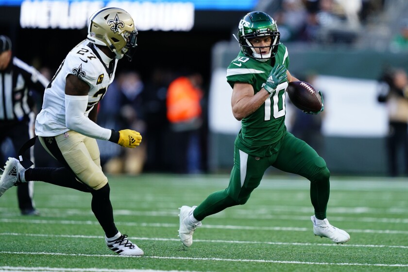 New York Jets' Braxton Berrios, right, runs with the ball during the second half of an NFL football game against the New Orleans Saints, Sunday, Dec. 12, 2021, in East Rutherford, N.J. (AP Photo/Matt Rourke)