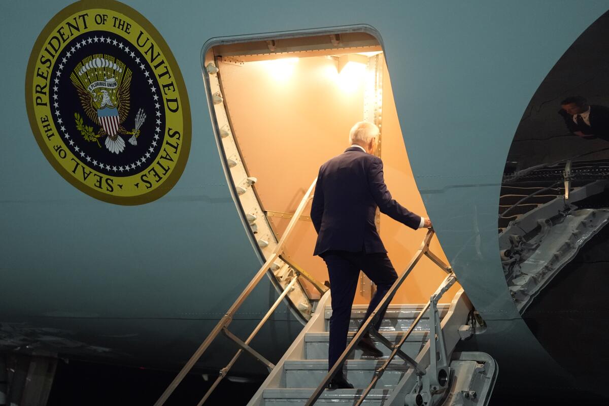 President Biden seen from behind boarding Air Force One.