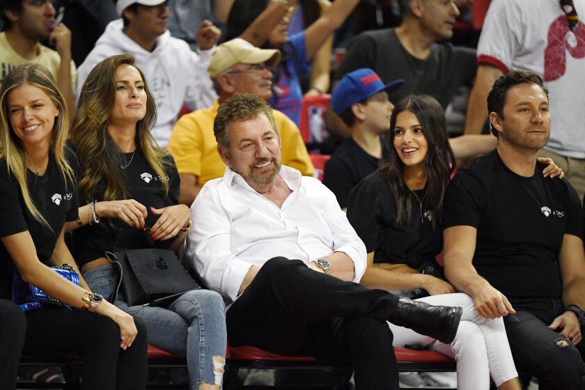 LAS VEGAS, NEVADA - JULY 07: (3rd L-R) Executive chairman and CEO of The Madison Square Garden Company and executive chairman of MSG Networks James L. Dolan, model Marcela Braga and Tao Group partner Jason Strauss attend a game between the New York Knicks and the Phoenix Suns during the 2019 NBA Summer League at the Thomas & Mack Center on July 7, 2019 in Las Vegas, Nevada. NOTE TO USER: User expressly acknowledges and agrees that, by downloading and or using this photograph, User is consenting to the terms and conditions of the Getty Images License Agreement. (Photo by Ethan Miller/Getty Images)